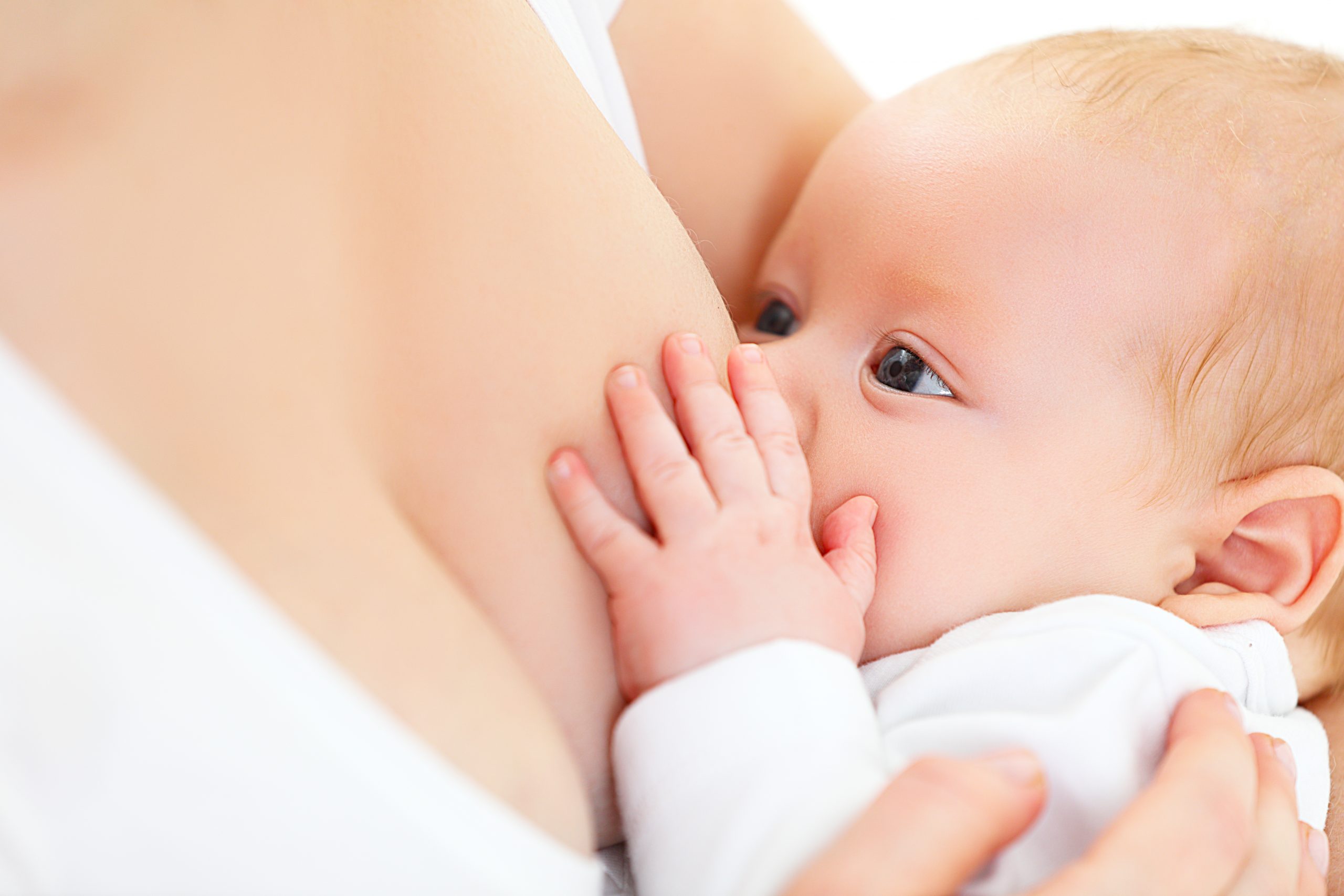 breastfeeding. mother holding newborn baby in an embrace and breastfeed